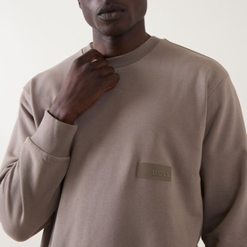 Model wearing Boss Green Label SW Logo Patch Sweatshirt in light pastel green, crew neck with tonal logo patch detail at chest
