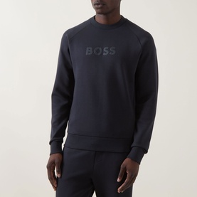 Model wearing Boss Green Label Salbo Logo Sweatshirt in dark blue, crew neck with tonal logo, styled with matching dark blue joggers.