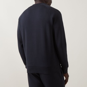 Model wearing Boss Green Label Salbo Logo Sweatshirt in dark blue, crew neck, ribbed trims, styled with matching dark blue trousers, rear view.