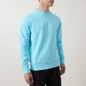Model wearing Boss Green Label Open Blue cotton crew neck sweatshirt with tonal embossed logo, styled with black trousers