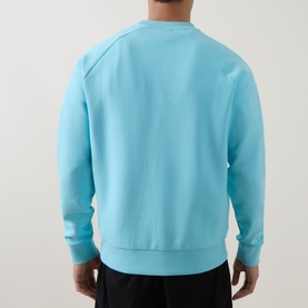 Model wearing Boss Green Label Open Blue cotton crew neck sweatshirt, rear view, styled with black trousers
