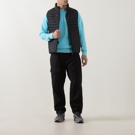 Model wearing Boss Green Label Open Blue cotton crew neck sweatshirt, styled with black quilted gilet and black cargo trousers.
