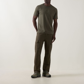 Model wearing Boss Green Label Open Green crew neck T-shirt with matching cargo trousers and grey trainers.