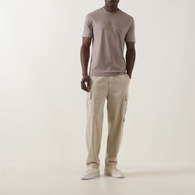 Model wearing Boss Green Label Light/Pastel Green cotton crew neck T-shirt, styled with beige cargo trousers and white trainers