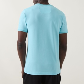 Model wearing Boss Green Label Taul Logo T-Shirt in Open Blue, back view, crew neck, short sleeves, straight hem, paired with black trousers