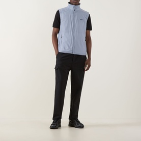 Model wearing Boss Green Label Lite X Logo Gilet in dark grey, zip-front sleeveless design, styled with black tee, cargo trousers and boots