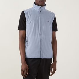 Model wearing Boss Green Label Lite X Logo Gilet in dark grey, zip-front sleeveless style, styled with black T-shirt and trousers.
