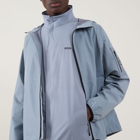 Model wearing Boss Green Label Lite X Logo Gilet in Dark Grey, high neck, front zip, over a long-sleeve top