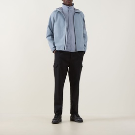 Model wearing Boss Green Label Lite X Logo Gilet in dark grey, styled with a light blue zip jacket and black cargo trousers.