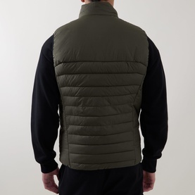 Model wearing Boss Green Label Urbanex Hybrid Gilet in Open Green, rear view, quilted sleeveless design with elasticated hem, styled with black