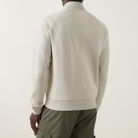 Model wearing Boss Green Label Logo Half-Zip Sweatshirt in Light Beige, back view, with olive cargo trousers.