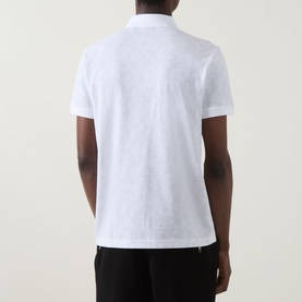 Model wearing Boss Green Label Swing Printed Logo Polo Shirt in white, rear view, with black trousers. Short sleeves, polo collar.