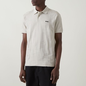 Model wearing Boss Green Label light beige polo shirt with tonal geometric pattern and small logo at chest, short sleeves