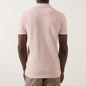 Model wearing Boss Green Label Paddy Logo Tipped Polo Shirt in light pastel orange, rear view, with tipped collar detail and short sleeves.