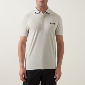 Model wearing Boss Green Label Paul Pro Logo Polo Shirt in light beige with contrast tipping collar and chest logo, styled with dark trousers.