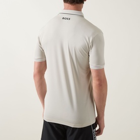 Model wearing Boss Green Label Paul Pro Logo Polo Shirt in light beige, back view showing logo detail and navy trim collar.