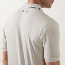 Model wearing Boss Green Label Paul Pro Logo Polo Shirt in Light Beige, rear view showing BOSS logo detail and contrast trim cuffs.