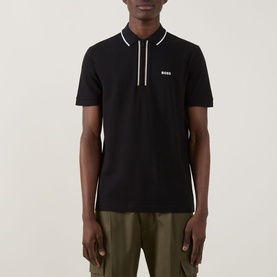 Model wearing Boss Green Label Philix GOC Logo Zip Polo Shirt in black with stripe zip placket and contrast logo, styled with khaki trousers