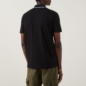 Model wearing Boss Green Label Philix GOC Logo Zip Polo Shirt in black, rear view, with contrast stripe collar detail and olive trousers.