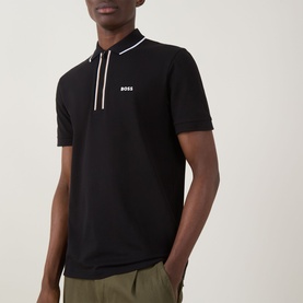 Model wearing Boss Green Label Philix GOC Logo Zip Polo Shirt in black with white stripe zip placket detail and contrast logo, styled with khaki