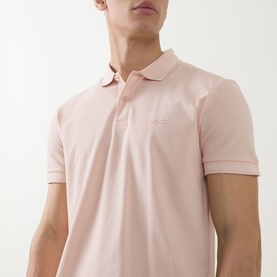 Model wearing Boss Green Label polo in light pastel orange, slim fit with ribbed collar and tonal embroidered logo on chest