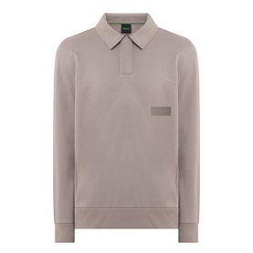 Boss Green Label long-sleeve cotton polo in light pastel green with collar, zip placket, and tonal logo patch at chest.