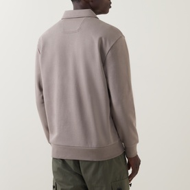 Model wearing Boss Green Label Light/Pastel Green cotton polo sweatshirt, rear view, styled with khaki cargo trousers.