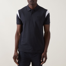 Model wearing Boss Green Label dark blue polo shirt with white contrast shoulder panels and tonal logo detail.