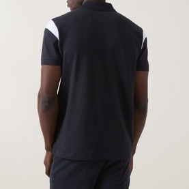 Model wearing Boss Green Label dark blue polo shirt, rear view, with white chevron shoulder panel detail and short sleeves