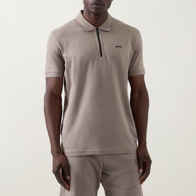 Model wearing Boss Green Label light green cotton polo shirt with quarter-zip neckline, short sleeves, and small logo detail