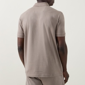 Model wearing Boss Green Label polo in light pastel green, rear view, short sleeves, ribbed collar, shown with matching trousers