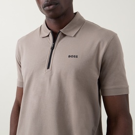 Model wearing Boss Green Label light pastel green zip-neck polo shirt with contrast black zip and logo embroidery at chest.