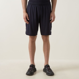 Model wearing Boss Green Label dark blue polyester shorts, styled with dark trainers
