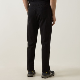 Model wearing Boss Green Label black sweat bottoms, rear view, styled with dark open-toe sandals