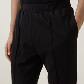 Model wearing Boss Green Label black sweat bottoms with elasticated waistband, front seam detail and side pockets