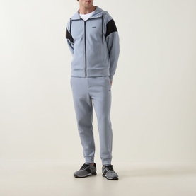 Model wearing Boss Green Label Dark Grey sweat bottoms with matching zip-through hoodie, styled with grey trainers