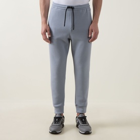 Model wearing Boss Green Label dark grey sweat bottoms with elasticated drawstring waist and ribbed cuffs, styled with grey trainers