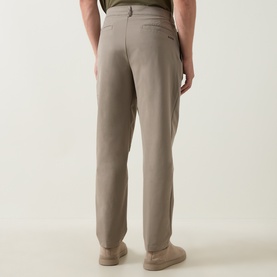 Model wearing Boss Green Label TR Commuter Pleated Trousers in light pastel green, rear view, tapered leg with pressed creases and welt pockets