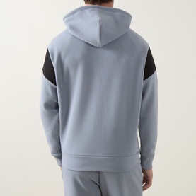 Model wearing Boss Green Label Union Saggy Logo Zip Hoodie in dark grey with black tennis-inspired shoulder inserts, styled with matching joggers.