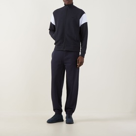 Model wearing Boss Green Label Union Skaz Zip Hoodie in dark blue with white contrast shoulder panel, styled with matching navy joggers and navy