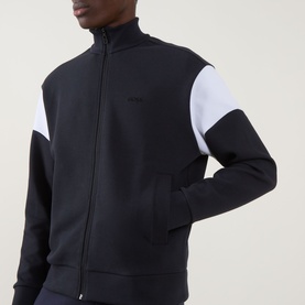 Model wearing Boss Green Label Union Skaz Zip Hoodie in dark blue with white contrast shoulder panel, funnel neck, and front zip fastening