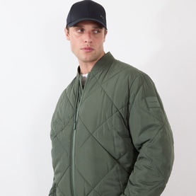 Model with Hugo Boss Zed-Boss-Me UV Cap in black, six-panel style with logo detail, styled with olive quilted bomber jacket.