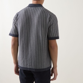 Model wearing Hugo Boss Orange Kodd Stripe Shirt in dark blue, rear view showing vertical stripe knit pattern, short sleeves and flat collar