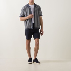 Model wearing Hugo Boss Orange Kodd Stripe Shirt in dark blue, styled with navy shorts and navy trainers