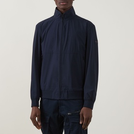 Model wearing Hugo Boss Orange Qlik Logo Windbreaker in dark blue, funnel neck, zip front, styled with dark cargo trousers