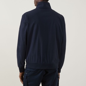 Model wearing Hugo Boss Orange Qlik Logo Windbreaker in dark blue, back view showing funnel neck, ribbed hem, and zip pockets