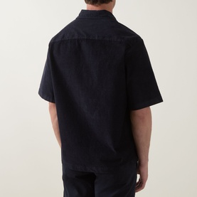 Model wearing Hugo Boss Orange dark blue short-sleeve casual shirt, rear view, relaxed fit with camp collar, paired with navy trousers.
