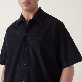 Model wearing Hugo Boss Orange dark blue short-sleeve casual shirt in textured cotton, with tonal logo embroidery at chest.