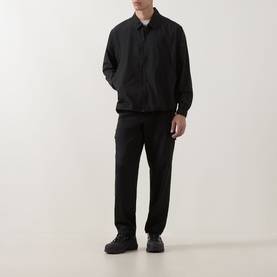 Model wearing Hugo Boss Orange black casual shirt with button placket, styled with matching black trousers and dark trainers
