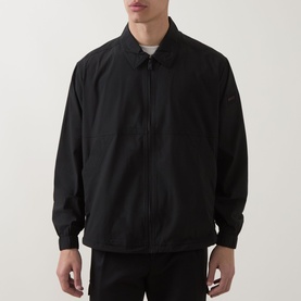 Model wearing Hugo Boss Orange black zip-up shirt jacket with spread collar and ribbed cuffs, styled with white crew neck tee